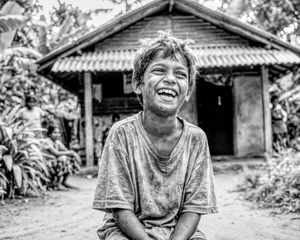 A child laughing outside a home